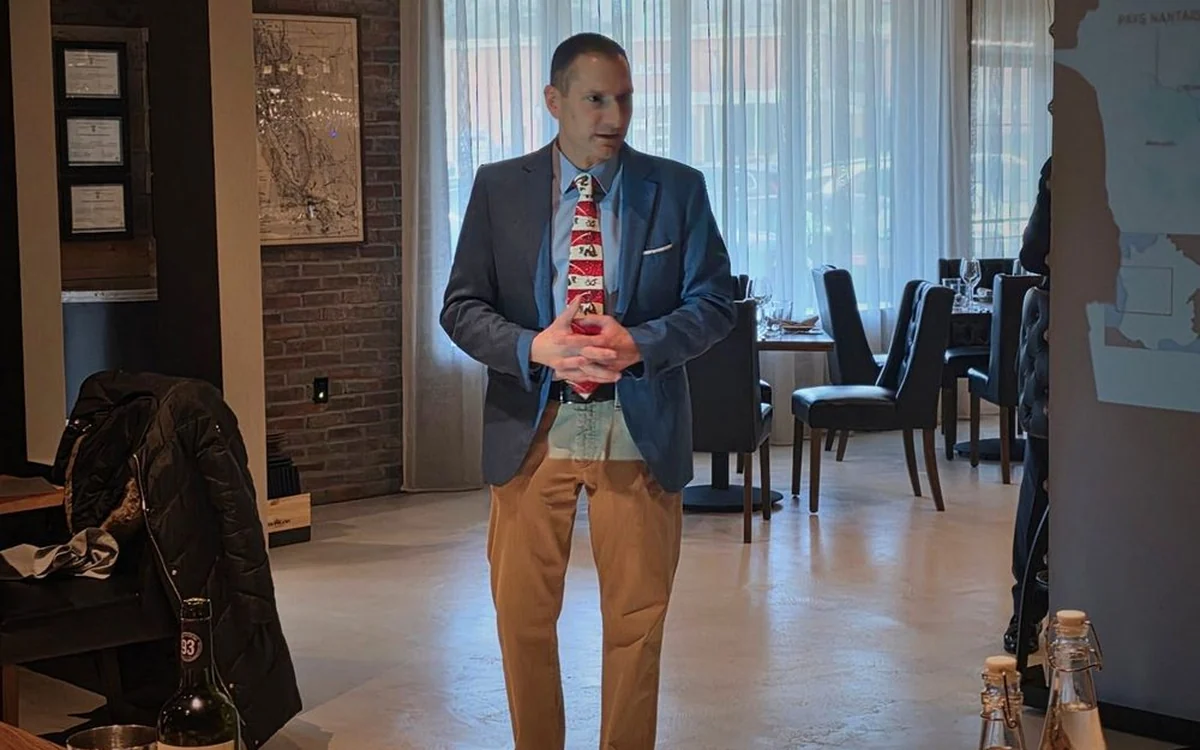 A sommelier leading a wine class at Enology Wine Bar and Bistro in Saint James